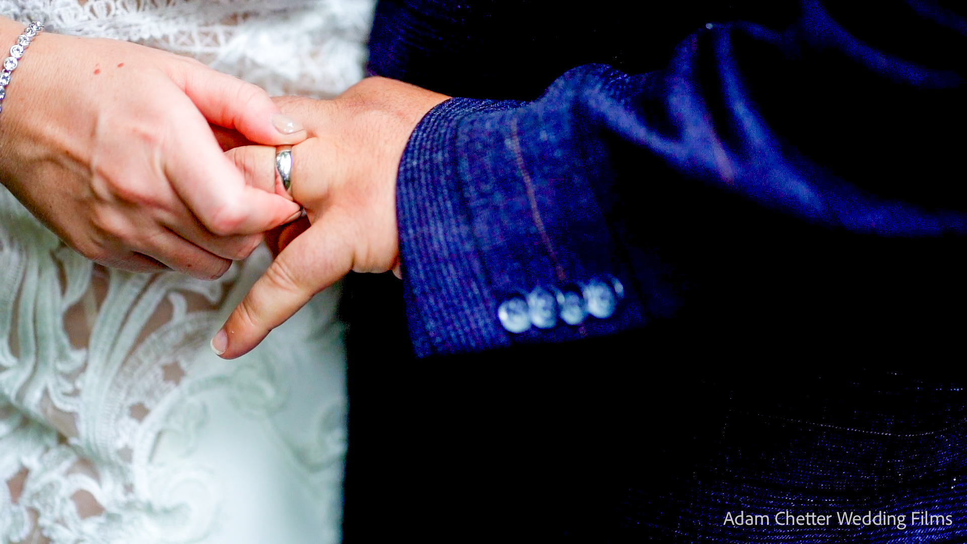 Bride Touching Grooms Wedding Ring