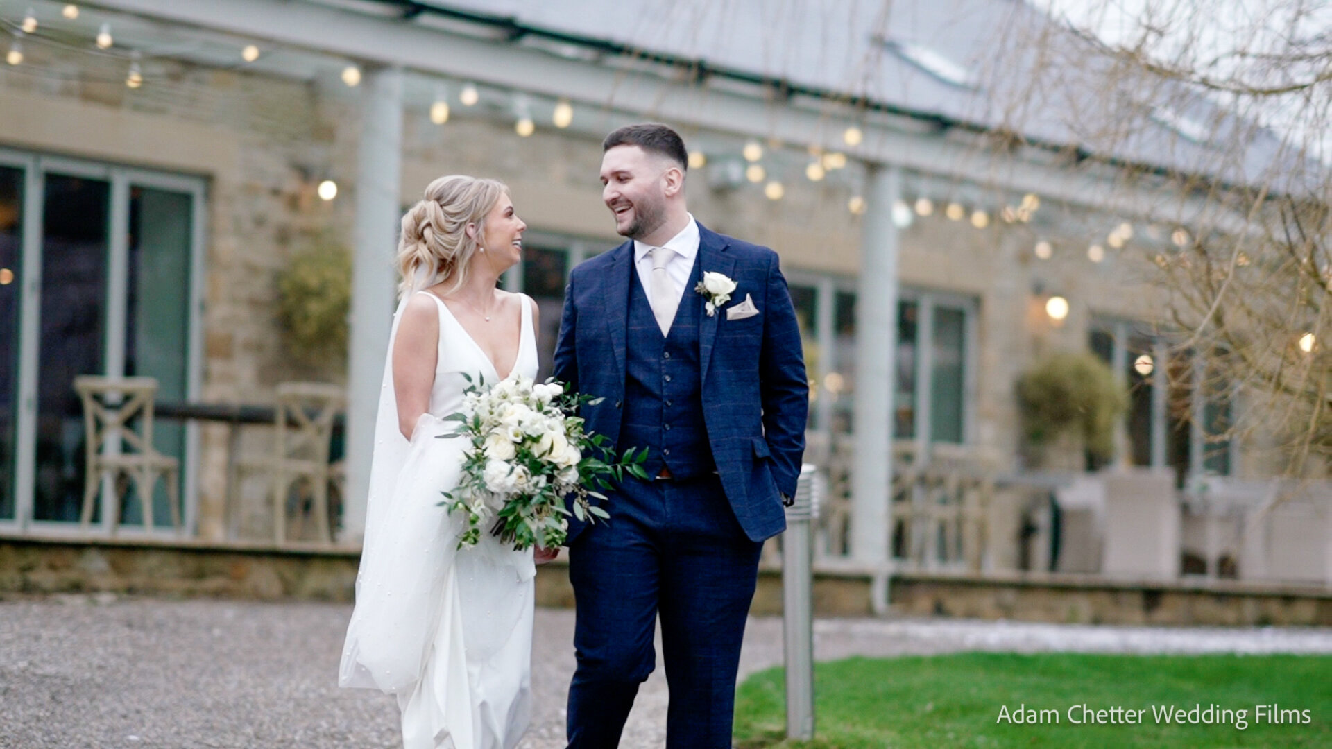 Bride In White Wedding Dress and Groom in Navy Suit