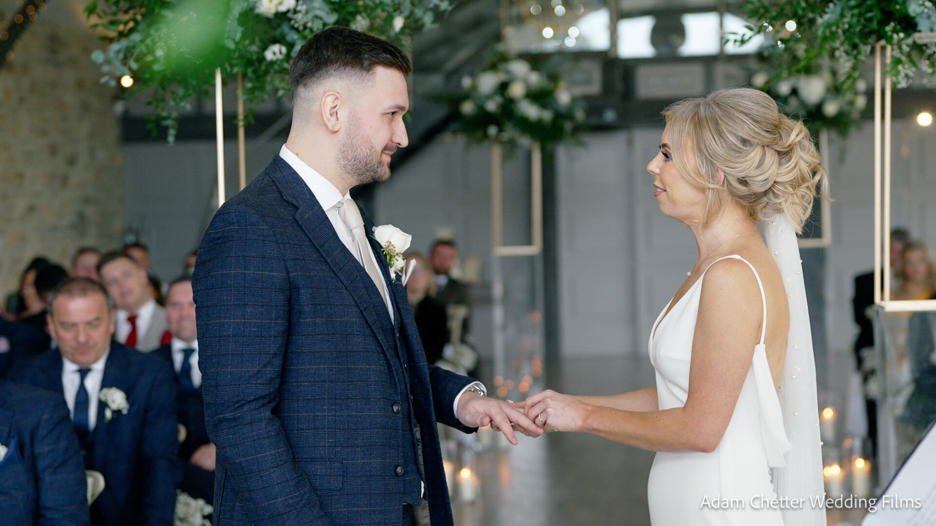 Bride Placing Ring On Grooms Finger