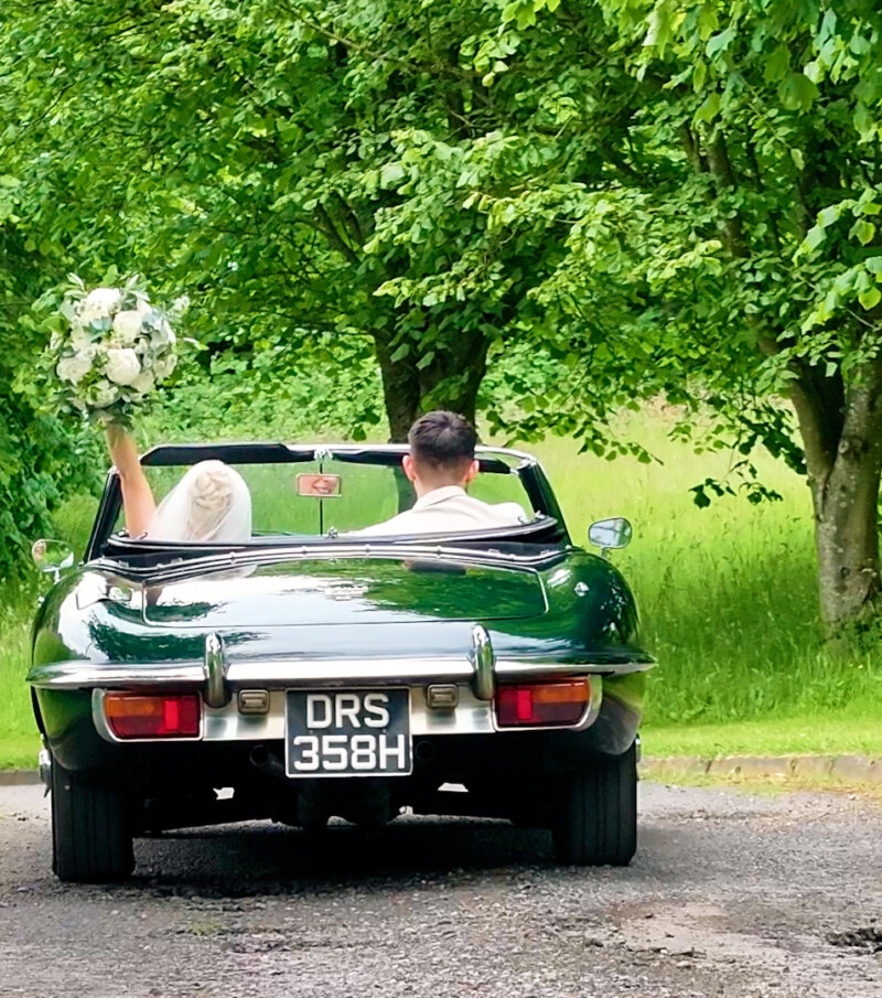 Bride and Groom Drive Off In Wedding Car